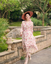 a lady wears pink floral printed maxi dress with lantern sleeves design